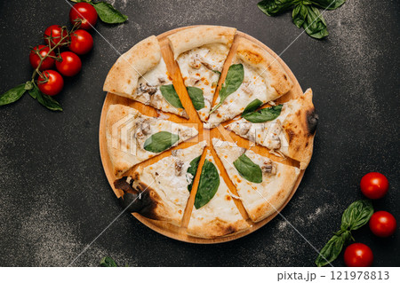 Wood-fired white pizza slices with mushrooms, spinach, and creamy cheese on a rustic wooden plate Wood-fired white pizza slices with mushrooms, spinach, and creamy cheese on a rustic wooden plate 121978813