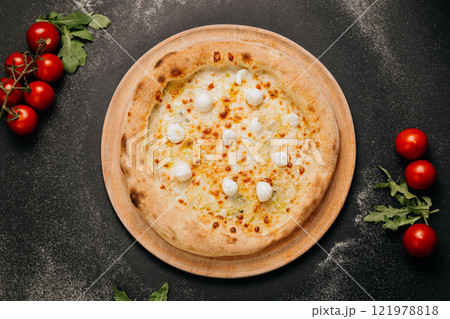 Delicious gourmet pizza with melted cheese and mozzarella balls, baked to golden perfection 121978818