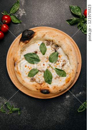 Gourmet white pizza with creamy mozzarella, mushrooms, and fresh spinach on a rustic wooden plate Gourmet white pizza with creamy mozzarella, mushrooms, and fresh spinach on a rustic wooden plate 121978823