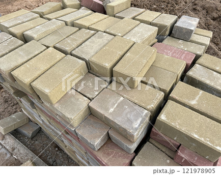 The cobblestones are stacked in neat piles 121978905