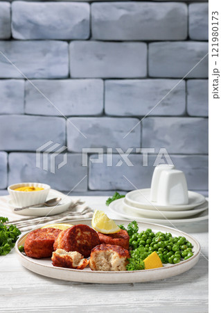 Danish atlantic cod fish cakes with green peas 121980173