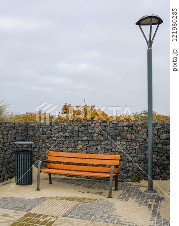 New modern seaside environmental object with gabion wall, bench, trash can and LED lighting 121980285