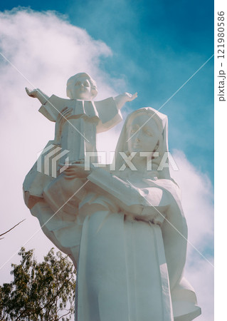 Vung Tau Beach with Blue Sky Flowers and Mother Mary Statue Scenic Coastal View with Coffee Shop Nearby High quality photo 121980586
