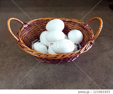 chicken eggs in a basket on a black background 121981855