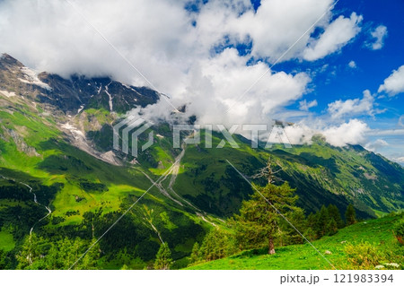 Picturesque Mountain Landscape with Lush Green Hills and Clouds in Kaprun, Austria 121983394
