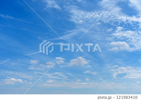A breathtaking view of a clear blue sky adorned with fluffy white clouds drifting lazily overhead A breathtaking view of a clear blue sky adorned with fluffy white clouds drifting lazily overhead 121983410