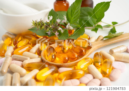 Alternative medicine herbal organic capsule with vitamin E omega 3 fish oil, mineral, drug with herbs leaf natural supplements for healthy good life. Alternative medicine herbal organic capsule with vitamin E omega 3 fish oil, mineral, drug with herbs leaf natural supplements for healthy good life. 121984783