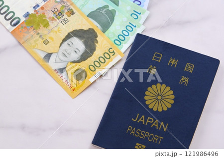韓国の通貨、ウォンKRWの紙幣と、パスポート（一般旅券5年用紺色）で、韓国旅行のイメージ 121986496