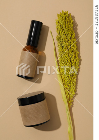 Cosmetic oil in a brown bottle with decorations 121987316