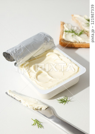 Philadelphia cheese in a plastic container, on a white background. 121987339