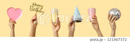 Birthday party accessories, set of hands with birthday party accessories on beige background Birthday party accessories, set of hands with birthday party accessories on beige background 121987372
