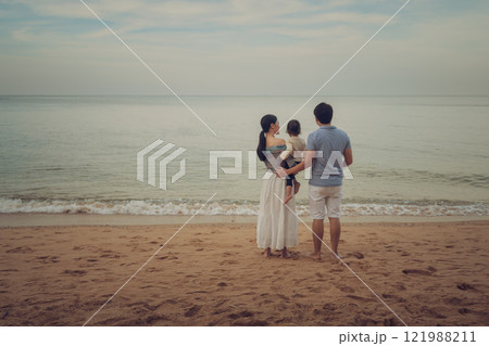 toddler baby girl with her father and mother. happy family on sea beach  in Pattaya, Thailand 121988211