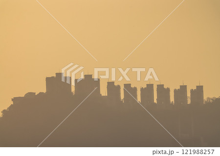 Historic Structures Amidst Hazy Golden Evening Sky Jan 11 2025 121988257