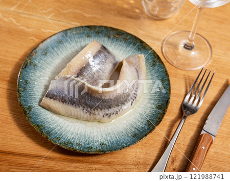 Close up slices of slightly salted herring with parsley Close up slices of slightly salted herring with parsley 121988741