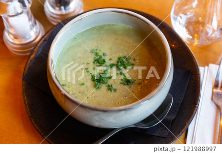 Healthy vegetable puree soup served with chopped fresh greens Healthy vegetable puree soup served with chopped fresh greens 121988997
