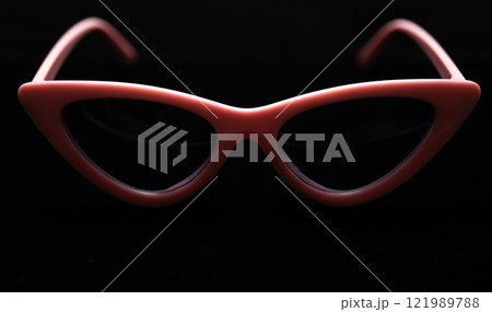 cat eye sunglasses lying on black background. High quality photo cat eye sunglasses lying on black background. High quality photo 121989788
