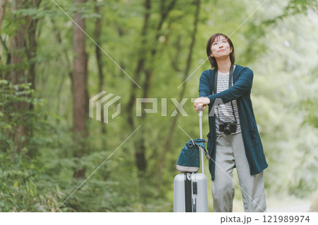 山道でスーツケースを転がす観光客 121989974