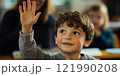 A young student eagerly raises his hand in a classroom setting. His bright smile shows enthusiasm for learning. This image captures the joy of education in a vibrant and engaging style. AI 121990208