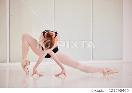 Art, ballet and creative ballerina dancing in a modern dance studio. Female classical dancer doing gymnastic training for a show. Elegant, fit and artistic athlete practicing her craft for a concert. 121990400