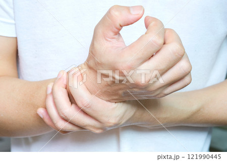 The young man touched his wrist with his hand. And he had bone and wrist pain. from hard work 121990445