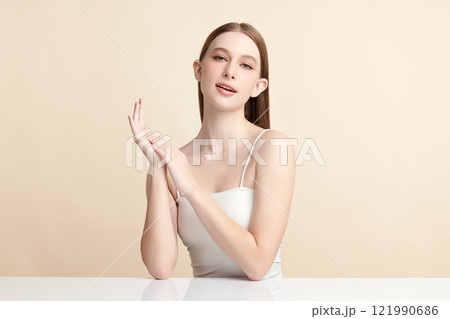 Beautiful young woman with clean fresh skin on beige background, Face care, Facial treatment, Cosmetology, beauty and spa, women portrait. 121990686