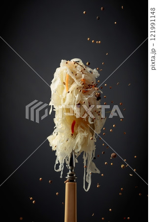 Traditional German sauerkraut with spices on a fork. 121991148