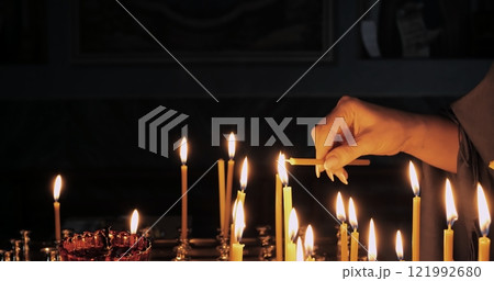Lighting Candles Symbolizing Deep Faith and Spiritual Devotion in a Sacred Space Creates Atmosphere for Reflection and Connection With Higher Power, Enhancing Prayer and Ritual Experience 121992680
