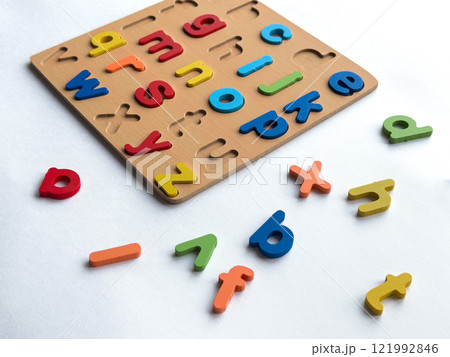 Colorful wooden alphabet puzzle for early childhood learning and development Colorful wooden alphabet puzzle for early childhood learning and development 121992846
