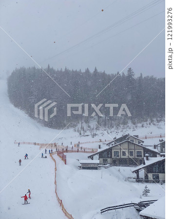 Snowy Ski Slope with Ski Lifts and Trees 121993276