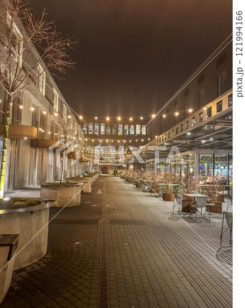 A quiet evening at an outdoor dining area, bathed in soft light. High quality photo 121994166