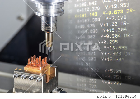Abstract scene the CNC milling machine cutting the copper electrode parts and G-code data background. 121996314