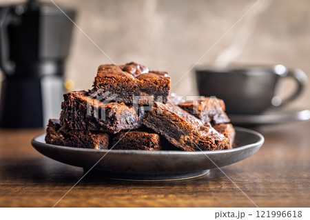 Homemade chocolate brownies on plate on wooden table. 121996618