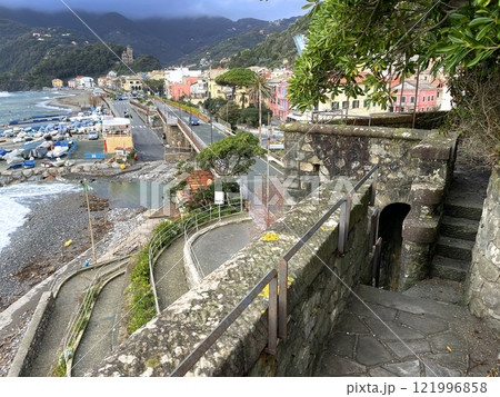 Old stone tower near sea in fall. View on town, beach and boats in Italy. Municipality Moneglia, Liguria region. View from mountain. Old stone tower near sea in fall. View on town, beach and boats in Italy. Municipality Moneglia, Liguria region. View from mountain. 121996858