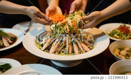 Group tossing traditional Asian salad together  Group tossing traditional Asian salad together  121996913