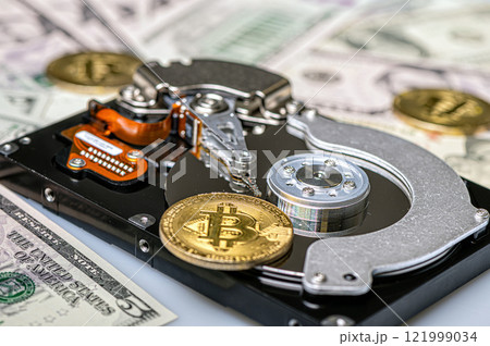 Bitcoin BTC coins, open hard drive and dollar bills, digital payment system concept Bitcoin BTC coins, open hard drive and dollar bills, digital payment system concept 121999034