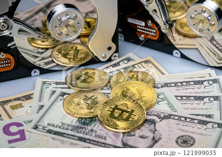 Bitcoin BTC coins, open hard drive and dollar bills, digital payment system concept Bitcoin BTC coins, open hard drive and dollar bills, digital payment system concept 121999035
