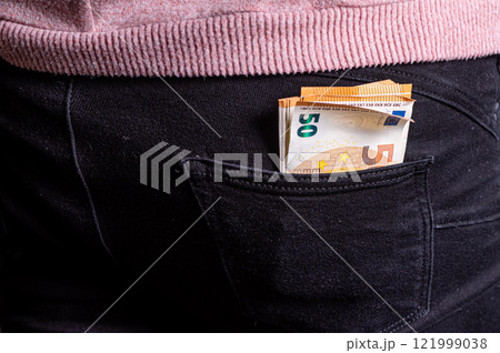 Euro banknotes in jeans back pocket. Concept of rich people, saving or spending money, closeup Euro banknotes in jeans back pocket. Concept of rich people, saving or spending money, closeup 121999038