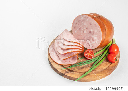 Tasty meat sausages. Turkey Boiled Ham on a wooden board, top view. copy space Tasty meat sausages. Turkey Boiled Ham on a wooden board, top view. copy space 121999074