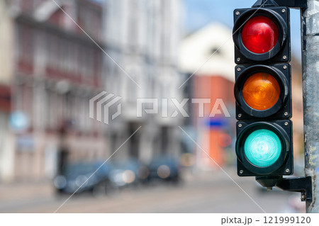 closeup of small traffic semaphore with green light against the backdrop of the city traffic closeup of small traffic semaphore with green light against the backdrop of the city traffic 121999120