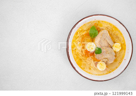 Quail broth or soup in a bowl on a white background top view. copy space Quail broth or soup in a bowl on a white background top view. copy space 121999143