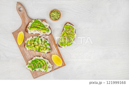 Set of toast with avocado and cheese. Vegan breakfast menu on a white background top view. copy space Set of toast with avocado and cheese. Vegan breakfast menu on a white background top view. copy space 121999168
