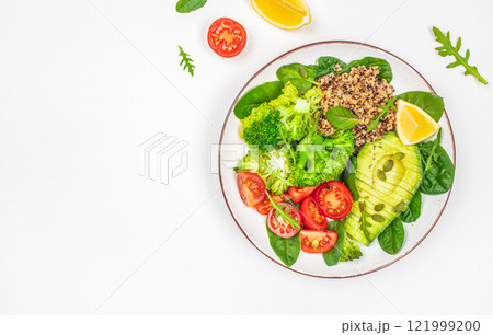 healthy vegan lunch bowl with avocado, broccoli, quinoa, tomatoes and fresh herbs on a white background top view. copy space healthy vegan lunch bowl with avocado, broccoli, quinoa, tomatoes and fresh herbs on a white background top view. copy space 121999200