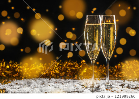 Two glass of champagne Festive background with light spots and bokeh. New Year and Merry Christmas concept. copy space Two glass of champagne Festive background with light spots and bokeh. New Year and Merry Christmas concept. copy space 121999260