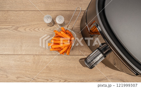 Homemade crispy sweet potato for air fryer oven on a wooden background. top view. copy space 121999307