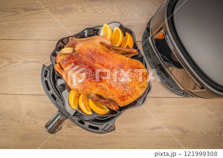 Air Fryer grilled whole duck on plate with oranges on a wooden background. top view. Thanksgiving or Christmas dinner 121999308