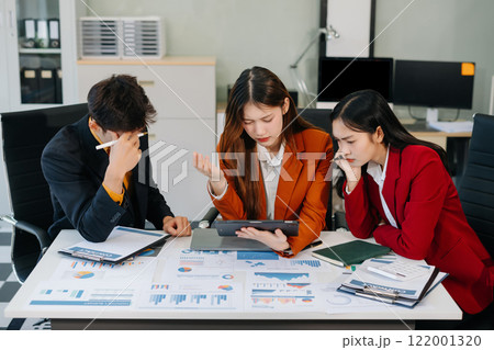 Businessman team working are under stress from financial data and report graph. Businessman team working are under stress from financial data and report graph. 122001320