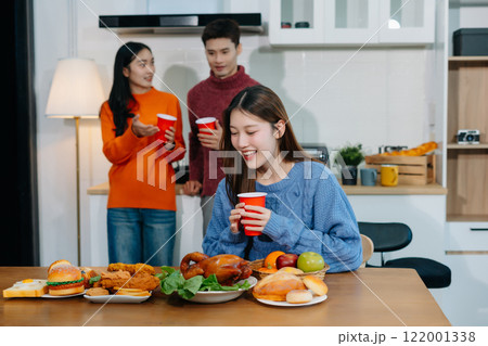 drinks and conversation, social gathering and get together. lifestyle young people, happy and celebrate with food at home. drinks and conversation, social gathering and get together. lifestyle young people, happy and celebrate with food at home. 122001338
