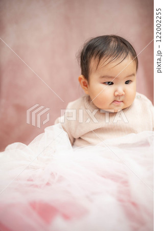 ピンクバックで座っている赤ちゃん ピンクバックで座っている赤ちゃん 122002255
