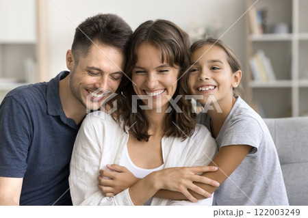 Little daughter enjoy moment of tenderness with loving parents 122003249
