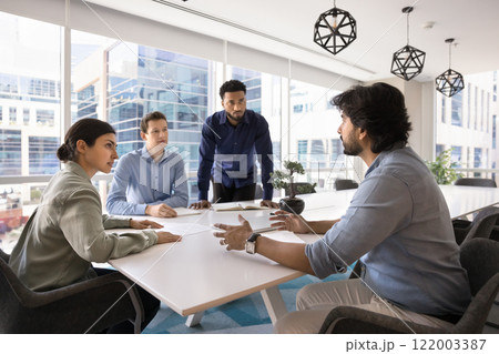 Diverse team of young managers working on startup together Diverse team of young managers working on startup together 122003387